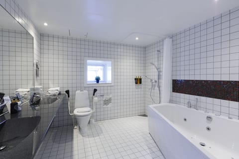 Junior Suite, Jetted Tub | Bathroom | Hair dryer, towels, soap, shampoo