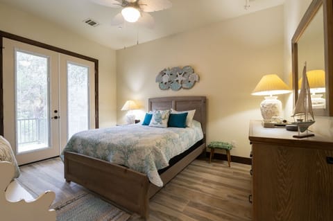 Queen Bed , Smart TV, Dresser and full length mirror in the master bedroom