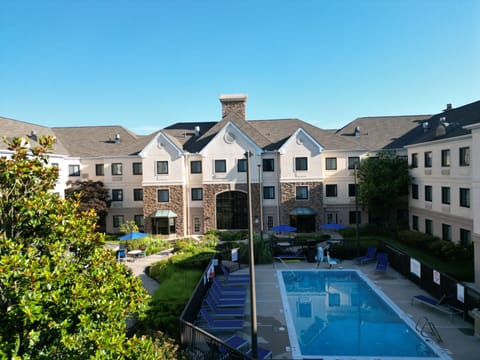 Seasonal outdoor pool, open 9:00 AM to 9:00 PM, pool umbrellas