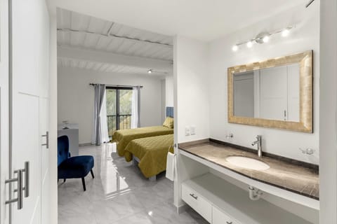 Deluxe Studio, Partial Ocean View | Bathroom | Shower, rainfall showerhead, eco-friendly toiletries, hair dryer