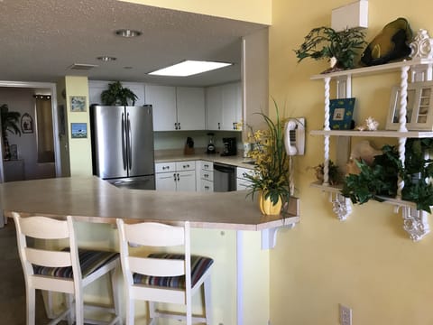 Open kitchen area with barstools. 