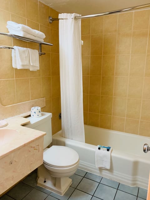 Double Room (2 Double Beds) | Bathroom | Combined shower/tub, hair dryer, towels