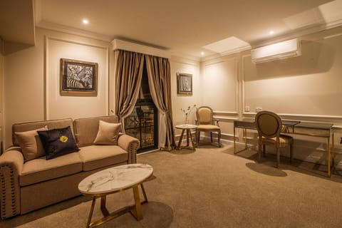 Luxury Class Junior Suite | Living room | 50-inch Smart TV with cable channels, TV, Netflix