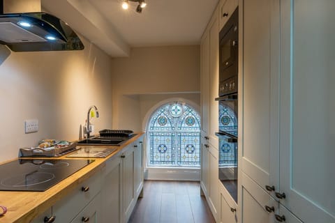 Kitchen with induction hob, two ovens and microwave.