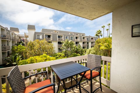 Relax on your private patio overlooking a running stream and lush greenery.