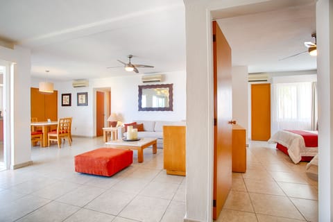 Emotions Select Two Bedroom Suite - No Elevator *200 USD Resort Credit | Living area | 32-inch LED TV with cable channels, TV, books
