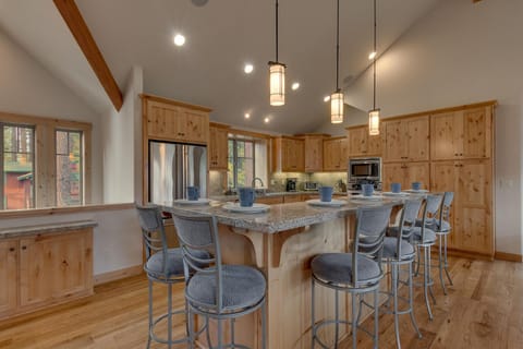 - Spacious kitchen with wood cabinetry
- Stainless appliances and stone counters
- Tahoe cabin rental with modern amenities