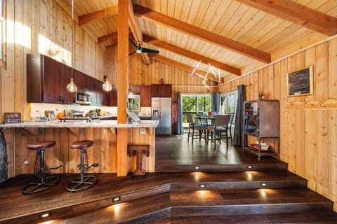 The kitchen is fully equipped and features both a dining table - The kitchen is fully equipped and features both a dining table and a breakfast bar for additional seating.