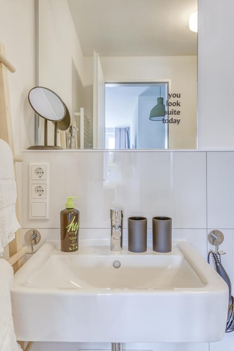 Suite M | Bathroom | Shower, hair dryer, towels, soap