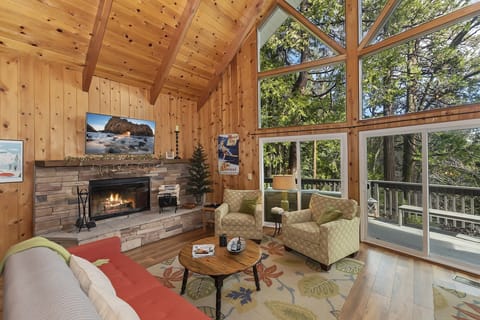 Living room with windows from floor to ceiling and cozy fireplace