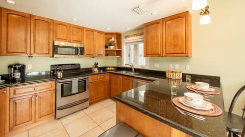 The kitchen is fully equipped with stainless steel appliances...