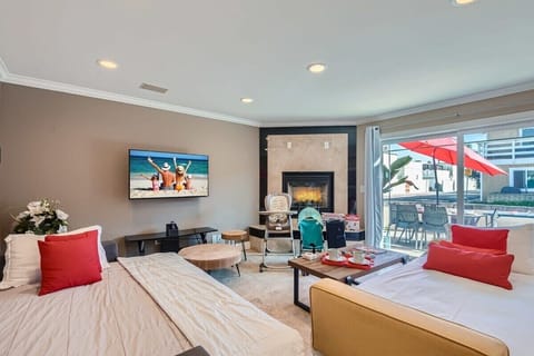 Open and beautiful living room design with two sofa that open to full size beds, 50” 4K TV, fireplace, games, beautiful decor, and so much more!