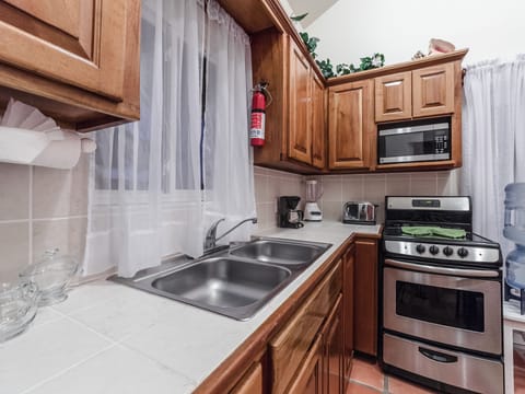 Standard Suite, 1 Bedroom, Pool View | Private kitchen | Fridge, microwave, oven, stovetop