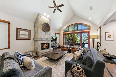 Sink into plush sofas by the crackling fireplace while you enjoy mountain views through soaring windows in this elegant retreat.