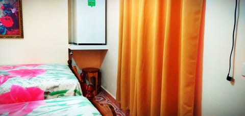 Economy Triple Room | Minibar, in-room safe, individually decorated, individually furnished