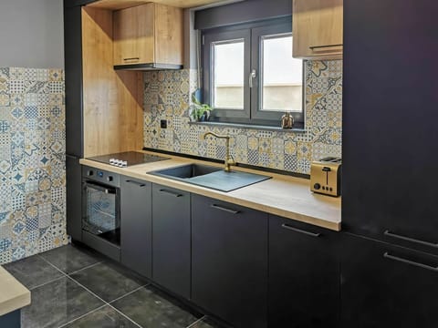 Countertop, Cabinetry, Building, Kitchen Stove, Kitchen, Window, Sink, Kitchen Appliance, Tap, Wood