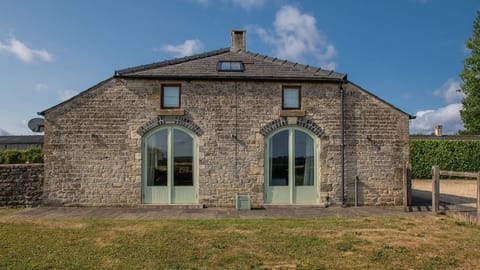 Oldbury Barn is a handsome Cotswold stone retreat wrapped in rolling valley views.