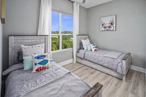 Guest room with 2 twin beds + two pull out twin trundles with sheets below.