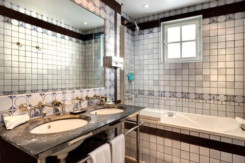 Bathtub, designer toiletries, hair dryer, bathrobes