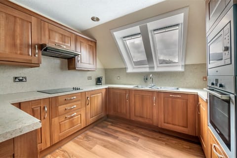 Traditional wooden kitchen, fully equipped for home-style cooking.