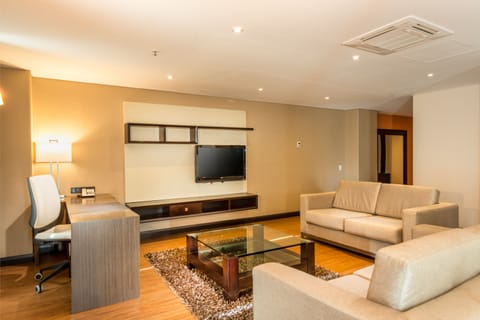 Luxury Suite | Living room | 32-inch LCD TV with satellite channels, TV