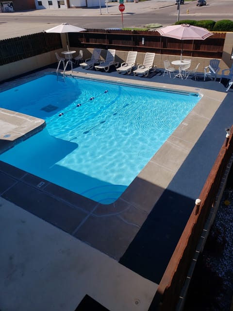 Seasonal outdoor pool, open 10:00 AM to 10:00 PM, pool umbrellas