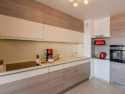 Cabinetry, Countertop, Property, Kitchen Stove, Kitchen Appliance, Building, Wood, Lighting, Orange, Kitchen