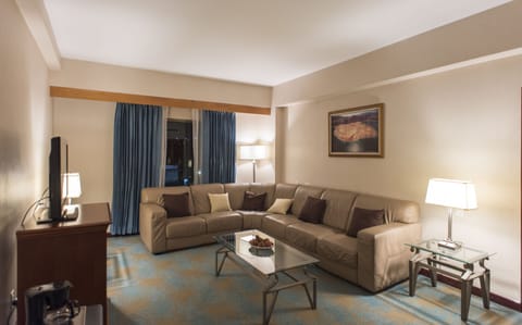 Suite, 1 King Bed | Living room | 37-inch plasma TV with cable channels, TV