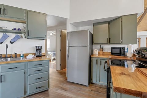 Kitchen and hallway leading to two bedrooms and the bathroom.