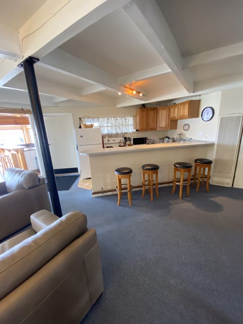 View towards Kitchen with Bar and stools.