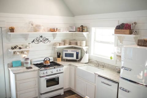 Open shelving with retro appliances in farmhouse kitchen