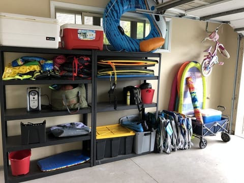 Pool toys, beach chairs, coolers, wagon... located in the garage