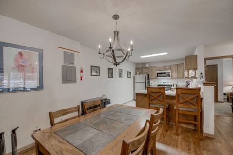 The dining table seats six with additional seating at the bar