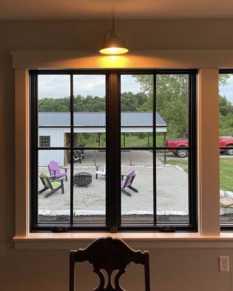 Looking out the sunroom to the fire pit and pavilion 