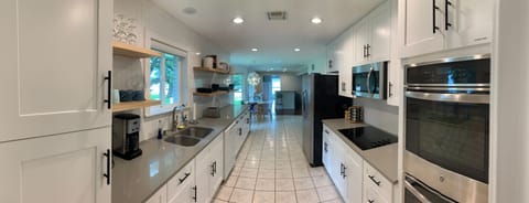Kitchen w/ double oven, stove top, microwave, dishwasher, lots of counter space