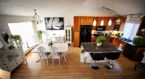 Full view of main level -vaulted ceilings, natural light, and hardwood floors.