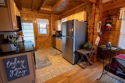 Kitchen area with private deck and hot tub off the back of the cabin.