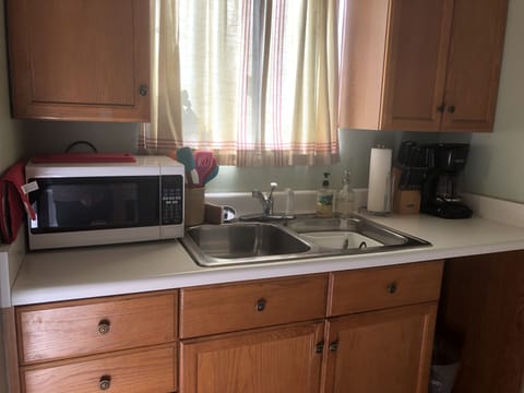 full kitchen sink with microwave and coffeemaker as well