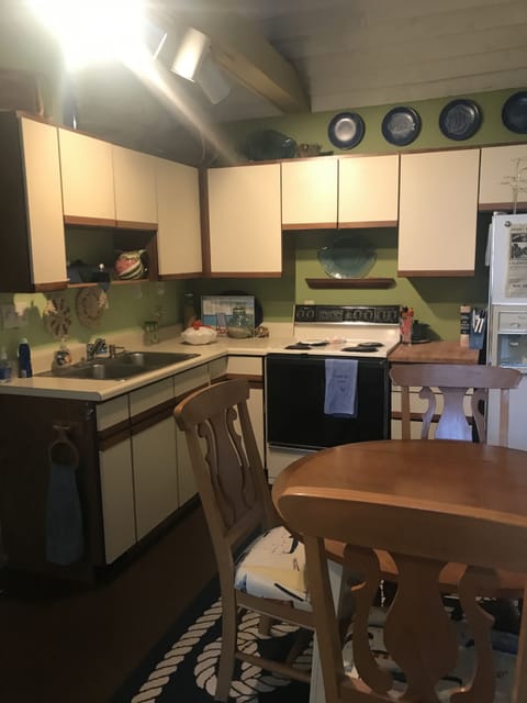 Kitchen with stove/oven, refrigerator and freezer, microwave and toaster oven.