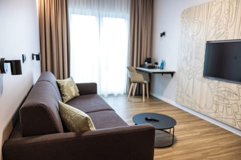 Hypo-allergenic bedding, desk, laptop workspace, blackout drapes