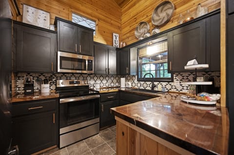 The kitchen is small, but fully stocked with full sized appliances!