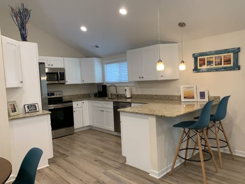 Fully equipped kitchen with stainless steel appliances.