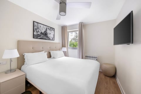 Relax in the serene bedroom featuring a plush Double bed and Parisian-themed decor, perfect for unwinding after a day exploring the city.