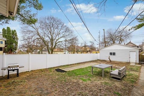 Propane grill, lounge seating, bocce ball court, outdoor dining amenities, 6' fence.