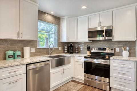 Fully updated kitchen boasting stainless steel appliances, ample counter space, and all the essentials needed to prepare delicious home-cooked meals