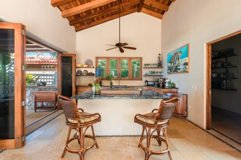 Fully stocked kitchen, island with 2 swivel chairs.