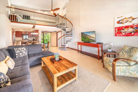 The spacious loft overlooks the living area, offering extra sleeping space and island charm.