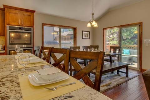 - Kitchen island with granite countertop
- Dining chairs and table set for meals
- Sliding doors open to outdoor deck
