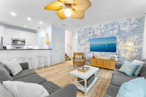 Wider shot of the living room. Did you know that this home is just 5 minutes from Destin Commons? There's tons of shops, restaurants, and gift stores to explore - and its all right outside the