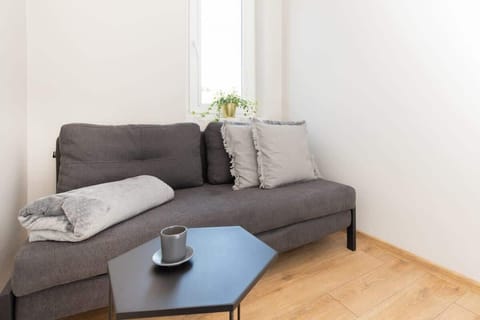 The elegant living room featuring a comfortable grey sofa perfect for relaxation.